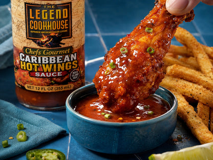 Close-up of Legend Wings Sauce used for dipping sauced wings with fries, dip, cool blue serving accents, and a secondary bottle.
