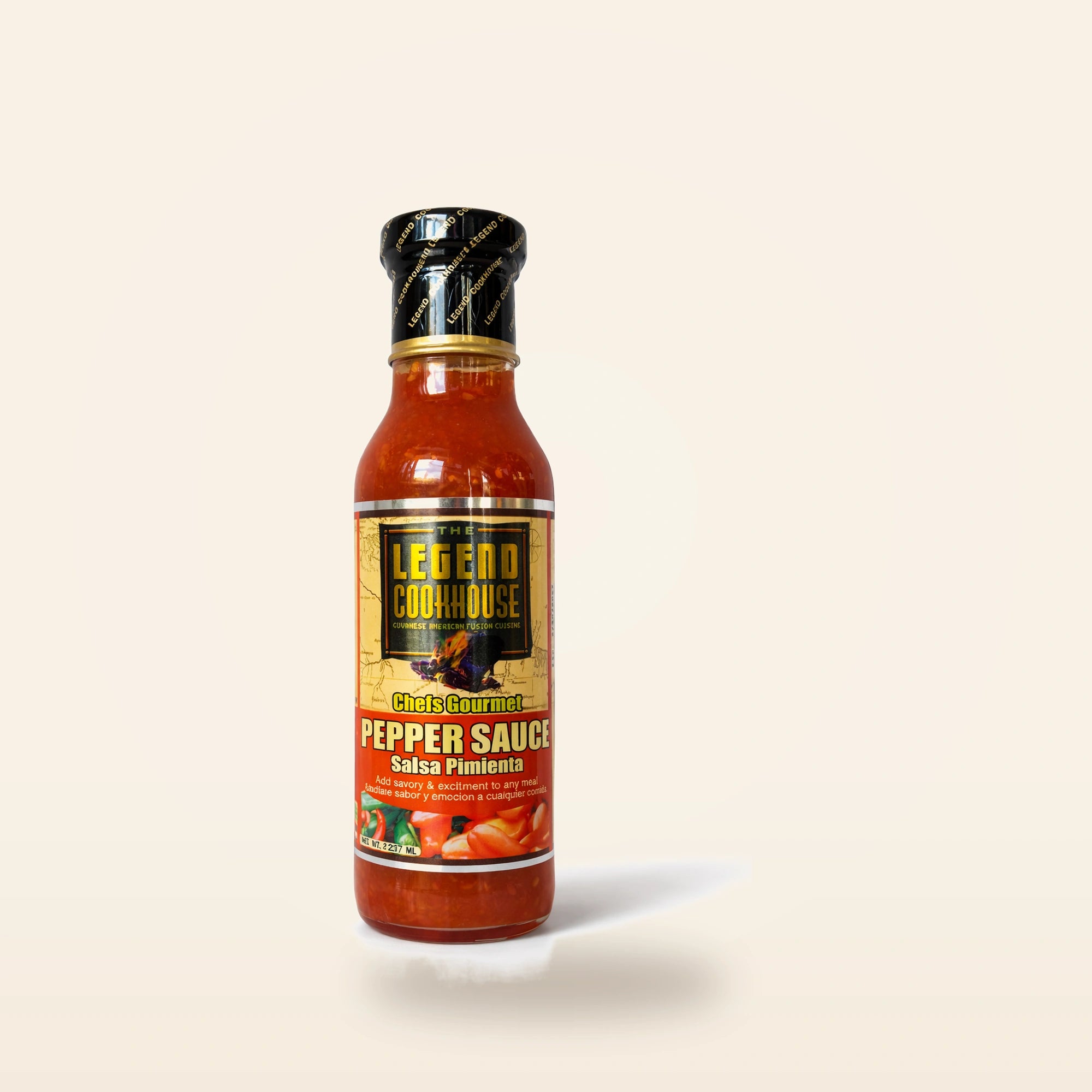 Legend Pepper Sauce bottle on a clean cream background with subtle pepper and garlic accents