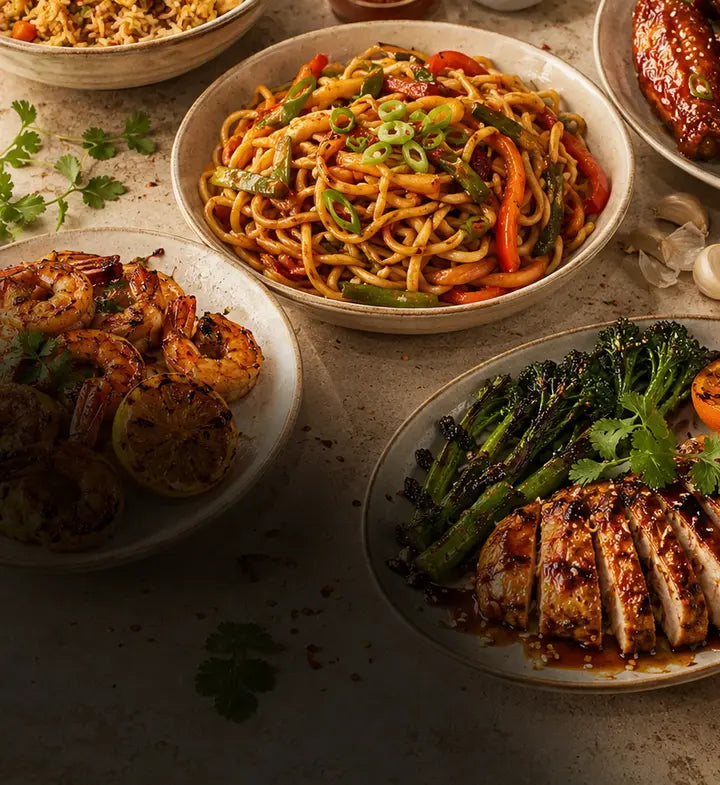 Premium home-cooking spread with rice, noodles, wings, shrimp, peppers, garlic, scallions, and Legend sauce cues for weeknight meals.