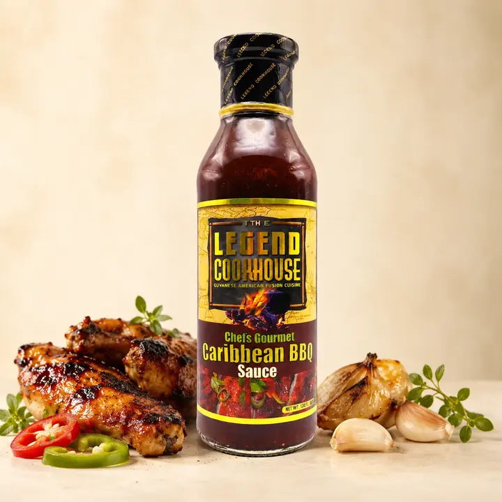 Legend Caribbean BBQ bottle with glazed chicken, garlic, peppers, herbs, and warm cream background
