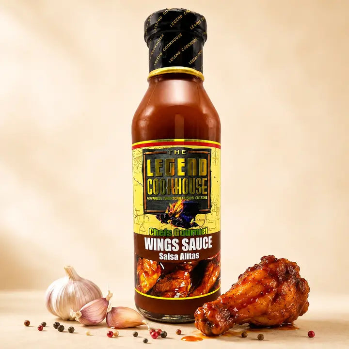 Legend Wings Sauce bottle with glazed wing, garlic, peppercorns, and warm cream background